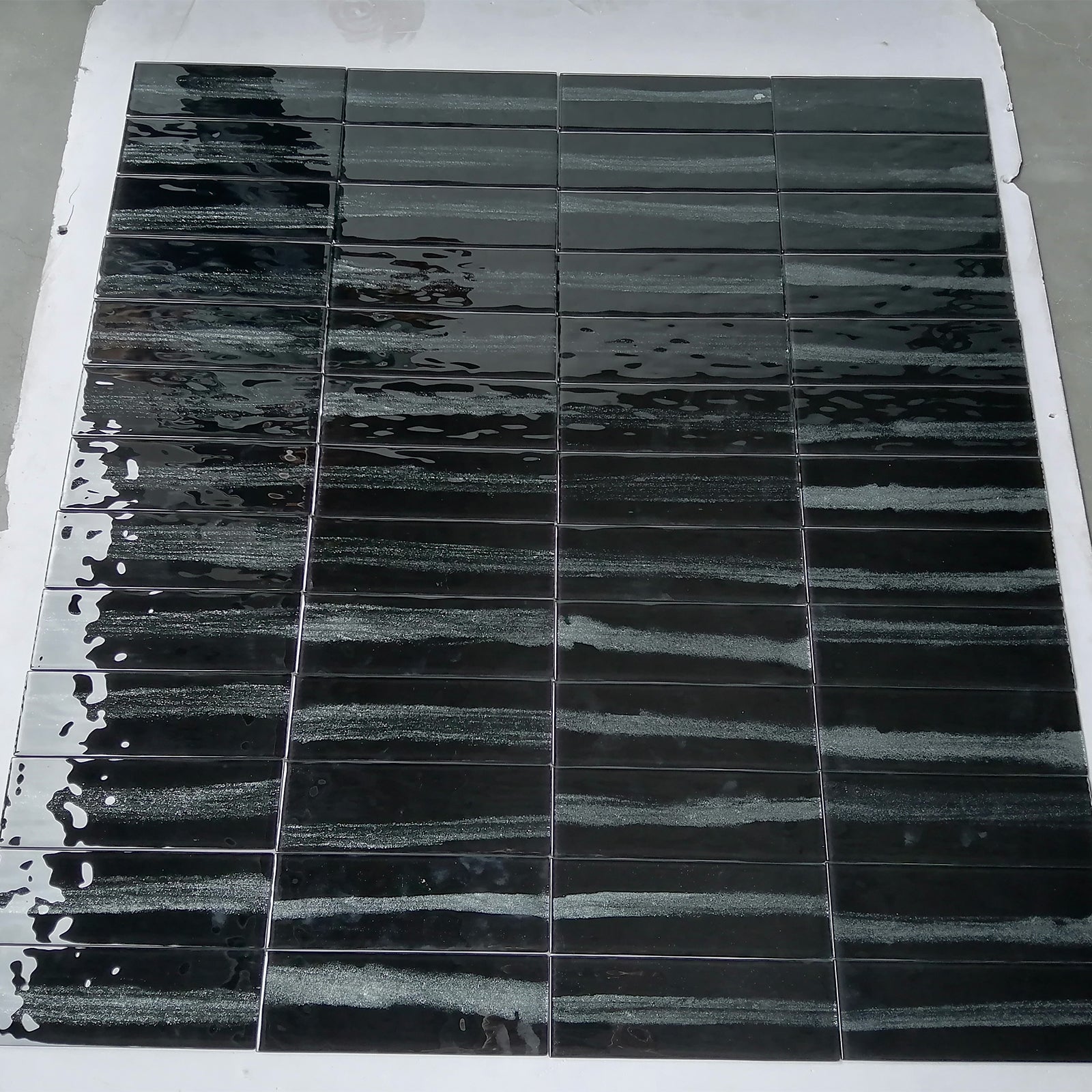 Polished glass tiles, a unique combination of black tone and pearlescent texture, adding a touch of mystery and romance to your home.