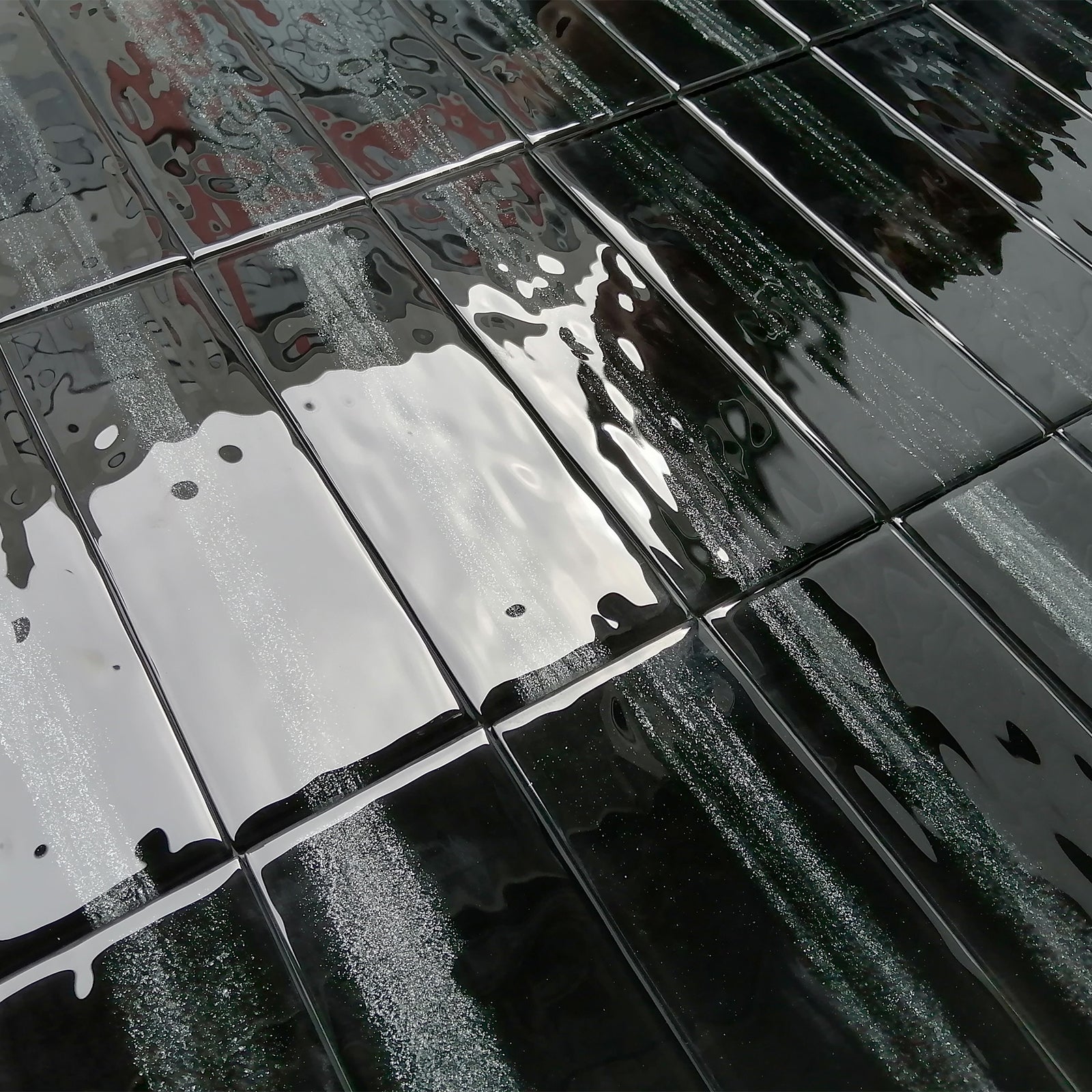 Black pearlized glass tiles, finely polished, each tile is as smooth as a mirror.
