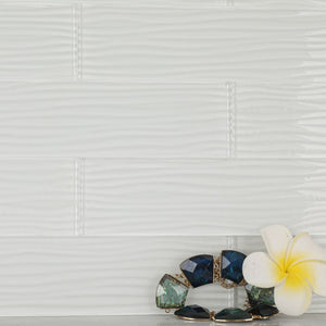 The white glass subway tiles with water ripples provide a different visual experience.