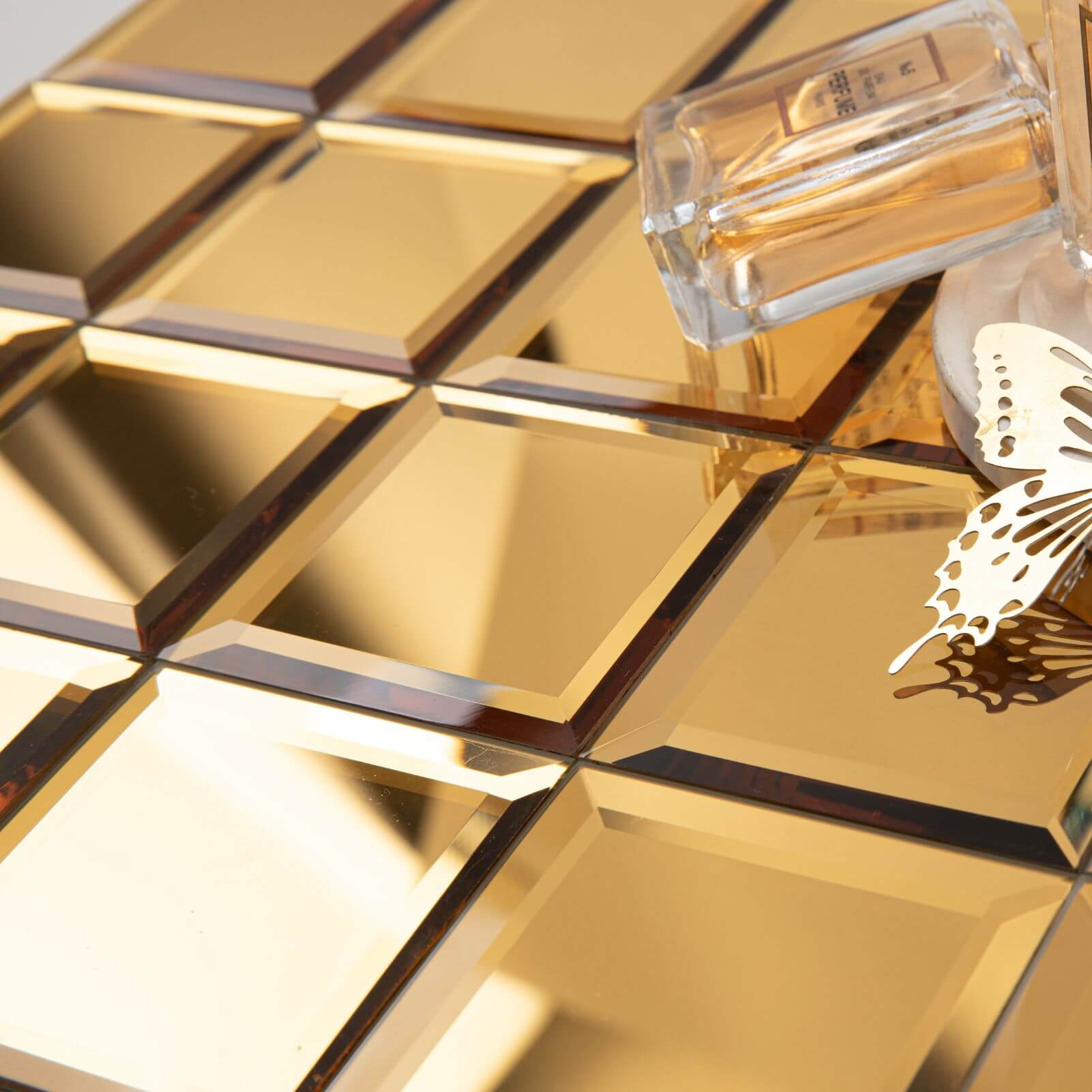 The shimmering surface of mirror glass tiles adds a touch of glamour and elegance to any room, creating a sense of grandeur and refinement.